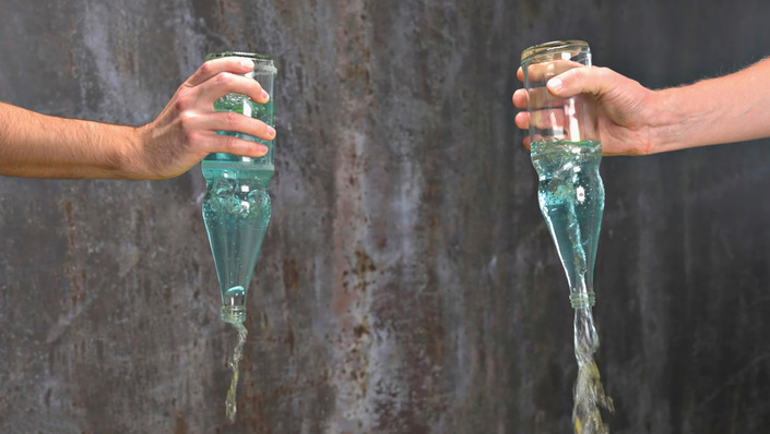 © Bild: Geberit Das Prinzip der durchgehenden Luftsäule mittels Rotationsbeschleunigung, einfach erklärt anhand eines Versuchs mit zwei gefüllten Wasserflaschen: Durch Schwenken der Flasche entsteht eine sichtbare Luftsäule, der Ausströmvolumenstrom erhöht sich deutlich.